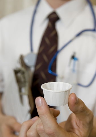 Doctor with Pills in Cup