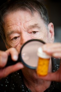 Man Examining Medication Bottle